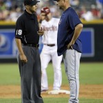 Cleveland Indians manager Terry Francona, right, talks with umpire Vic Carapazza as Arizona Diamondbacks' Gerardo Parra stands on second base during the sixth inning of a baseball game, Tuesday, June 24, 2014, in Phoenix. Parra was ruled safe after avoiding a tag while caught in a rundown. (AP Photo/Matt York)
