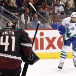 Arizona Coyotes' Mike Smith (41) makes a save on a shot by Vancouver Canucks' Nick Bonino (13) during the first period of an NHL hockey game Thursday, March 5, 2015, in Glendale, Ariz. (AP Photo/Ross D. Franklin)