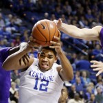 Kentucky's Karl-Anthony Towns (12) pulls down a rebound between Grand Canyon's Tobe Okafor (50) and Joshua Braun during the second half of an NCAA college basketball game, Friday, Nov. 14, 2014, in Lexington, Ky. Kentucky won 85-45. (AP Photo/James Crisp)