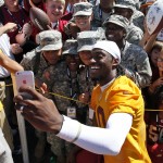 Washington Redskins quarterback Robert Griffin III takes a selfie with U.S. Army soldiers with Bravo Co. of the 244th Quartermaster Battalion from Fort Lee, Va., after practice at the team's NFL football training facility, Friday, July 25, 2014 in Richmond, Va. (AP Photo)