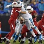 Arizona Cardinals' Ryan Lindley, left, is hit by Carolina Panthers' Charles Johnson, right, in the first half of an NFL wild card playoff football game in Charlotte, N.C., Saturday, Jan. 3, 2015. (AP Photo/Mike McCarn)