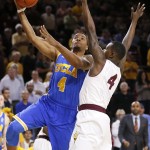 UCLA's Norman Powell, left, shoots over Arizona State's Gerry Blakes during the first half of an NCAA college basketball game, Wednesday, Feb. 18, 2015, in Tempe, Ariz. (AP Photo/Matt York)