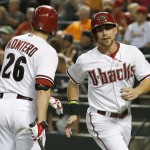 Arizona Diamondbacks' Ender Inciarte, right, celebrates his run scored against the St. Louis Cardinals with teammate Miguel Montero (26) during the first inning of a baseball game Friday, Sept. 26, 2014, in Phoenix. (AP Photo/Ross D. Franklin)