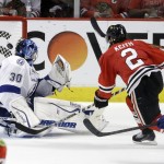 Chicago Blackhawks' Duncan Keith, right, scores past Tampa Bay Lightning goalie Ben Bishop during the second period in Game 6 of the NHL hockey Stanley Cup Final Monday, June 15, 2015, in Chicago. (AP Photo/Charles Rex Arbogast)
