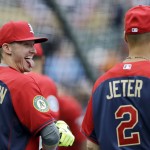 American League third baseman Josh Donaldson, left, of the Oakland Athletics, jokes with short stop Derek Jeter, of the New York Yankees, during batting practice for the MLB All-Star baseball game, Monday, July 14, 2014, in Minneapolis. (AP Photo/Jeff Roberson)