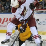 Arizona Coyotes right wing David Moss (18) jumps in front of Buffalo Sabres goaltender Matt Hackett (31) on an incoming shot during the second period of an NHL hockey game Thursday, March 26, 2015, in Buffalo, N.Y. The Coyotes won in overtime 4-3. (AP Photo/Gary Wiepert)