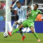  Argentina's Marcos Rojo, left, is challenged by Nigeria's Peter Odemwingie during the group F World Cup soccer match between Nigeria and Argentina at the Estadio Beira-Rio in Porto Alegre, Brazil, Wednesday, June 25, 2014. (AP Photo/Fernando Vergara)