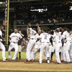 Houston Astros' Chris Carter, left, is congratulated by teammates after hitting a walk off home run to defeat the Arizona Diamondbacks 5 - 4 during the 10th inning of a baseball game, Thursday, June 12, 2014, in Houston. (AP Photo/Patric Schneider)
