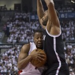 Toronto Raptors' Kyle Lowry, left, drives against Brooklyn Nets' Alan Anderson during the first half of Game 1 of an opening-round NBA basketball playoff series, in Toronto on Saturday, April 19, 2014. (AP Photo/The Canadian Press, Chris Young)