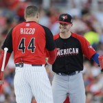 National League's Anthony Rizzo, left, of the Chicago Cubs, is greeted by American League's Josh Donaldson, of the Toronto Blue Jays, during the MLB All-Star baseball Home Run Derby, Monday, July 13, 2015, in Cincinnati. (AP Photo/Jeff Roberson)