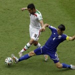  Bosnia defender Emir Spahic, right, kicks the ball away from Iran forward Reza Ghoochannejhad during the second half of a group F World Cup soccer match at the Arena Fonte Nova in Salvador, Brazil, Wednesday, June 25, 2014. (AP Photo/Themba Hadebe)