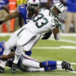 New York Jets running back Chris Ivory (33) is stopped by Buffalo Bills linebacker Larry Dean (54) during the second half of an NFL football game in Detroit, Monday, Nov. 24, 2014. (AP Photo/Paul Sancya)