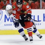 Tampa Bay Lightning's Tyler Johnson, left, and Chicago Blackhawks' Patrick Kane chase after a loose puck during the first period in Game 6 of the NHL hockey Stanley Cup Final series on Monday, June 15, 2015, in Chicago. (AP Photo/Nam Y. Huh)