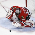 Chicago Blackhawks goalie Corey Crawford smothers a puck during the first period in Game 6 of the NHL hockey Stanley Cup Final series against the Tampa Bay Lightning on Monday, June 15, 2015, in Chicago. (AP Photo/Charles Rex Arbogast)