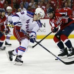 Washington Capitals defenseman Matt Niskanen (2) steals the puck from New York Rangers left wing Chris Kreider (20) during the second period of Game 3 in the second round of the NHL Stanley Cup hockey playoffs, Monday, May 4, 2015, in Washington. (AP Photo/Alex Brandon)