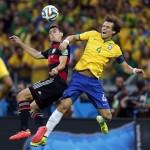 Germany's Miroslav Klose, left, and Brazil's David Luiz go for a header during the World Cup semifinal soccer match between Brazil and Germany at the Mineirao Stadium in Belo Horizonte, Brazil, Tuesday, July 8, 2014. (AP Photo/Frank Augstein)