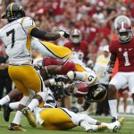 Alabama wide receiver Christion Jones is tackled by Southern Mississippi defensive back Emmanuel Johnson (12) during the first half of an NCAA college football game Saturday, Sept. 13, 2014, in Tuscaloosa, Ala. (AP Photo/Brynn Anderson)