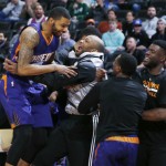 Phoenix Suns forward Marcus Morris, left, is congratulated by guard P.J. Tucker, second from left, and the rest of the Suns after Morris made a shot from half-court against the Denver Nuggets at the end of the first quarter of an NBA basketball game Wednesday, Feb. 25, 2015, in Denver. (AP Photo/David Zalubowski)