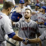 New York Mets' Anthony Recker (20) gets a handshake from bench coach Bob Geren, right, and a high-five from teammate Ike Davis, after Recker hit a home run against the Arizona Diamondbacks during the second inning of a baseball game on Wednesday, April 16, 2014, in Phoenix. (AP Photo/Ross D. Franklin)