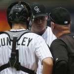 Colorado Rockies catcher Nick Hundley, front left, confers with starting pitcher Tyler Matzek, center, and pitching coach Steve Foster after Matzek walked the bases loaded against the Arizona Diamondbacks in the first inning of the first game of a baseball doubleheader Wednesday, May 6, 2015, in Denver. (AP Photo/David Zalubowski)