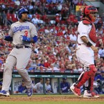 Los Angeles Dodgers left fielder Carl Crawford scores in front of St. Louis Cardinals catcher Yadier Molina, right, during the sixth inning in Game 4 of baseball's NL Division Series, Tuesday, Oct. 7, 2014, in St. Louis. (AP Photo/Jeff Roberson)