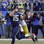 Seattle Seahawks' Jermaine Kearse catches the game-winning touchdown pass in front of Green Bay Packers' Tramon Williams during overtime of the NFL football NFC Championship game Sunday, Jan. 18, 2015, in Seattle. The Seahawks won 28-22 to advance to Super Bowl XLIX. (AP Photo/David J. Phillip)