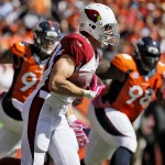 Arizona Cardinals tight end John Carlson runs the ball against the Denver Broncos during the first half of an NFL football game, Sunday, Oct. 5, 2014, in Denver. (AP Photo/Jack Dempsey)