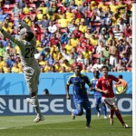 Ecuador's goalkeeper Alexander Dominguez leaps out to make a save in front of his goal during the group E World Cup soccer match between Switzerland and Ecuador at the Estadio Nacional in Brasilia, Brazil, Sunday, June 15, 2014. At right, Ecuador's Jorge Guagua and Switzerland's Valentin Stocker. (AP Photo/Marcio Jose Sanchez)