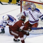 New York Rangers goalie Cam Talbot, right, makes a save on Arizona Coyotes center Antoine Vermette (50) as Derek Stepan (21) defends during the first period of an NHL hockey game, Saturday, Feb. 14, 2015, in Glendale, Ariz. (AP Photo/Rick Scuteri)