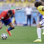 Chile's Alexis Sanchez, left, takes on Brazil's David Luiz during the World Cup round of 16 soccer match between Brazil and Chile at the Mineirao Stadium in Belo Horizonte, Brazil, Saturday, June 28, 2014. (AP Photo/Andre Penner)