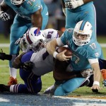 Miami Dolphins quarterback Ryan Tannehill (17) is sacked by Buffalo Bills defensive end Mario Williams, center, during the first half of an NFL football game, Thursday, Nov. 13, 2014, in Miami Gardens, Fla. Also on the play is Bills defensive end Manny Lawson (91). (AP Photo/Lynne Sladky)