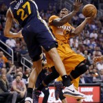 Utah Jazz forward Rudy Gobert (27) defends as Phoenix Suns guard Eric Bledsoe (2) shoots during the second half of an NBA basketball game, Friday, Feb. 6, 2015, in Phoenix. The Suns won 100-93. (AP Photo/Matt York)