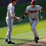Arizona Diamondbacks' Jake Lamb, right, is congratulated by third base coach Glenn Sherlock after hitting a solo home run during the fifth inning of a baseball game against the Colorado Rockies, Saturday, Sept. 20, 2014, in Denver. (AP Photo/Jack Dempsey)