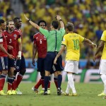 Referee Carlos Velasco Carballo from Spain tries to calm players during the World Cup quarterfinal soccer match between Brazil and Colombia at the Arena Castelao in Fortaleza, Brazil, Friday, July 4, 2014. (AP Photo/Andre Penner)