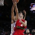 Serbia's Milos Teodosic pushes the ball up the basket against United States' Anthony Davis during the final World Basketball match between the United States and Serbia at the Palacio de los Deportes stadium in Madrid, Spain, Sunday, Sept. 14, 2014. (AP Photo/Daniel Ochoa de Olza)