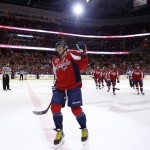 Washington Capitals left wing Alex Ovechkin, from Russia, comes to the bench to celebrate his goal in the first period of an NHL hockey game against the Arizona Coyotes, Sunday, Nov. 2, 2014, in Washington. (AP Photo/Alex Brandon)