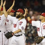 Washington Nationals' Jayson Werth, left, and Ian Desmond, right, are congratulated by teammates after the Nationals' 8-1 victory over the Arizona Diamondbacks in a baseball game at Nationals Park on Tuesday, Aug. 19, 2014, in Washington. (AP Photo/Evan Vucci)