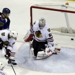 St. Louis Blues' Jaden Schwartz, top left, watches as his shot slips past Chicago Blackhawks goalie Corey Crawford and Johnny Oduya (27), of Sweden, for a goal during the third period in Game 1 of a first-round NHL hockey Stanley Cup playoff series Thursday, April 17, 2014, in St. Louis. (AP Photo/Jeff Roberson)
