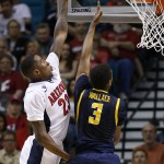 Arizona's Rondae Hollis-Jefferson, left, tries to block California's Tyrone Wallace in the second half of an NCAA college basketball game in the quarterfinals of the Pac-12 conference tournament Thursday, March 12, 2015, in Las Vegas. (AP Photo/John Locher)