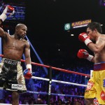Floyd Mayweather Jr., left, celebrates during his welterweight title fight against Manny Pacquiao, from the Philippines, on Saturday, May 2, 2015 in Las Vegas. (AP Photo/John Locher)