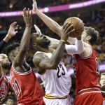 Cleveland Cavaliers forward LeBron James (23) shoots against Chicago Bulls guard Jimmy Butler, left, and forward Pau Gasol during the second half of Game 1 in a second-round NBA basketball playoff series Monday, May 4, 2015, in Cleveland. The Bulls won 99-92. (AP Photo/Tony Dejak)