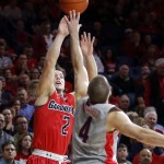 Gardner Webb guard Tyler Strange (2) shoots over Arizona guard T.J. McConnell (4) during the first half of an NCAA college basketball game, Tuesday, Dec. 2, 2014, in Tucson, Ariz. (AP Photo/Rick Scuteri)