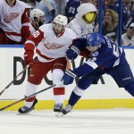 Detroit Red Wings left wing Drew Miller (20) and Tampa Bay Lightning defenseman Andrej Sustr, of the Czech Republic, battle for the puck during the first period of Game 7 of a first-round NHL Stanley Cup hockey playoff series Wednesday, April 29, 2015, in Tampa, Fla. (AP Photo/Chris O'Meara)