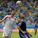  Iran's Pejman Montazeri, left, and Bosnia's Vedad Ibisevic battle for the ball during a group F World Cup soccer match between Bosnia and Iran at the Arena Fonte Nova in Salvador, Brazil, Wednesday, June 25, 2014. (AP Photo/Fernando Llano)