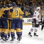 Chicago Blackhawks defenseman Duncan Keith (2) skates to the bench as Nashville Predators celebrate a goal by Colin Wilson (33) during the third period of Game 5 of an NHL hockey first-round playoff series Thursday, April 23, 2015, in Nashville, Tenn. (AP Photo/Mark Humphrey)
