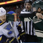 Linesman Steve Miller, center, tries to separate St. Louis Blues center Steve Ott (9) and Minnesota Wild left wing Matt Cooke, right, during the second period of Game 6 of an NHL hockey first-round playoff series in St. Paul, Minn., Sunday, April 26, 2015. (AP Photo/Ann Heisenfelt)