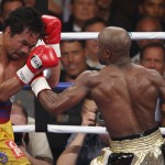 Floyd Mayweather Jr., right, hits Manny Pacquiao, from the Philippines, during their welterweight title fight on Saturday, May 2, 2015 in Las Vegas. (AP Photo/Eric Jamison)