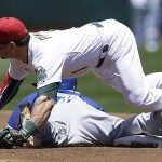 Oakland Athletics' Nick Punto, top, falls on Toronto Blue Jays' Jose Reyes after Reyes stole second base in the first inning of a baseball game on Friday, July 4, 2014, in Oakland, Calif. (AP Photo/Ben Margot)