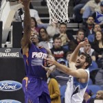 Phoenix Suns' Eric Bledsoe, left, makes a reverse layup as Minnesota Timberwolves' Ricky Rubio defends during the second half of an NBA basketball game, Friday, Feb. 20, 2015, in Minneapolis. The Timberwolves won 111-109. (AP Photo/Jim Mone)