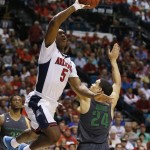 Arizona's Stanley Johnson shoots over Oregon's Dillon Brooks during the second half of an NCAA college basketball game in the championship of the Pac-12 conference tournament Saturday, March 14, 2015, in Las Vegas. Arizona won 80-52. (AP Photo/John Locher)